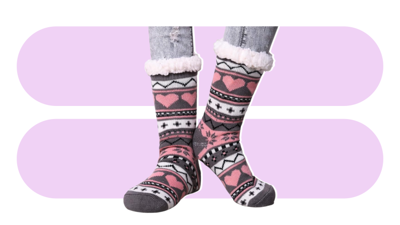 A pair of pink and gray Dosoni socks against a purple background.
