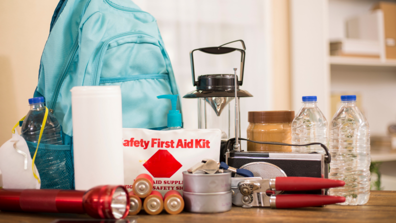 Emergency preparedness kit with first aid items and a backpacks.