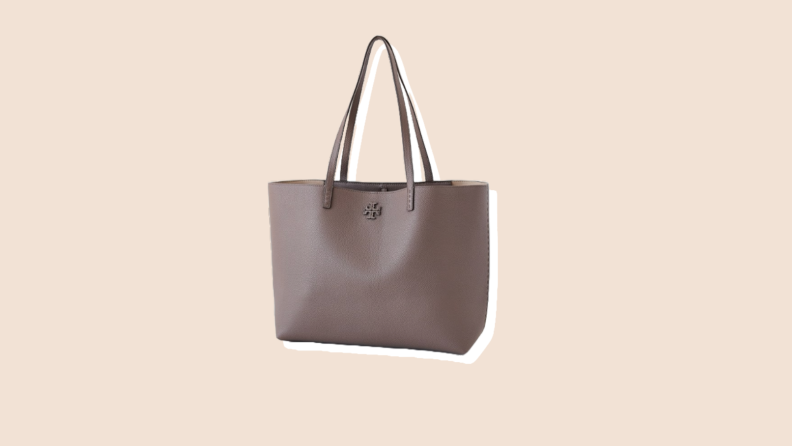 Photo of the Tory Burch McGraw Tote against a beige background.