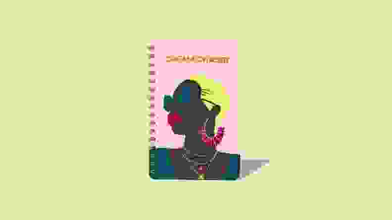 A journal with an artistic design featuring a black woman.