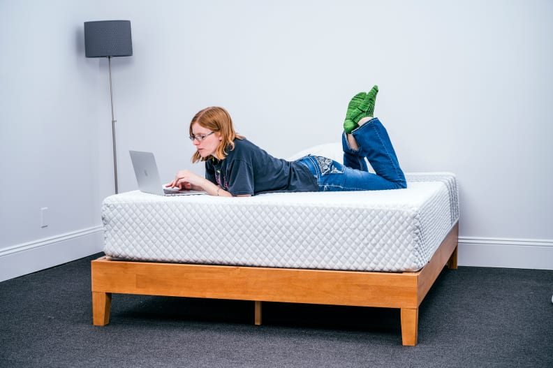 a woman lies on the Leesa mattress in a bedroom