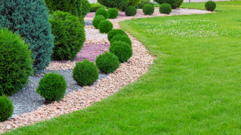 Rock mulch in landscaped yard outdoors.