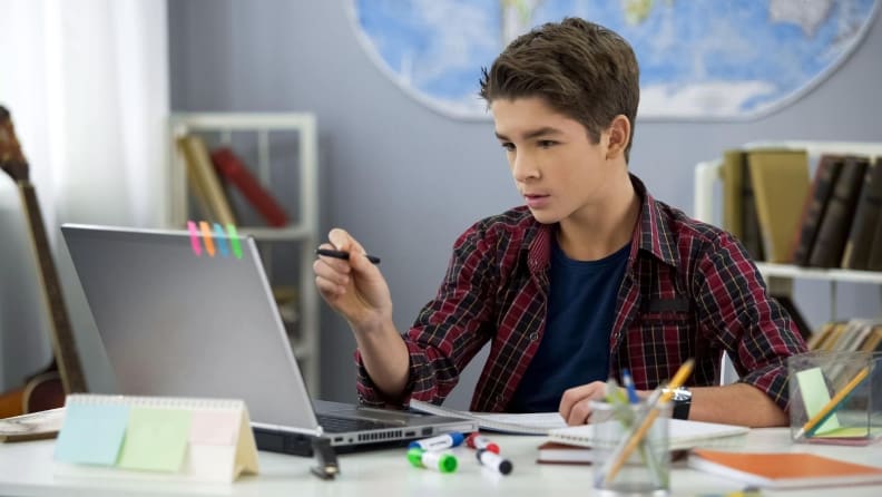 Boy at desk on computer