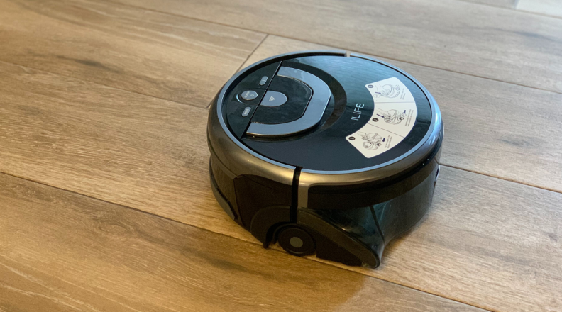 The iLife Shinebot W400 robot mop is shown cleaning wood-look tile floors.