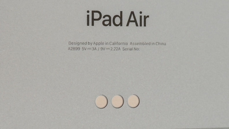 A closeup of a Space Grey iPad Air's pogo pins