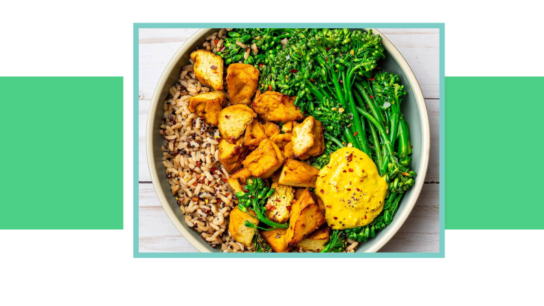 Prepared meal with tofu, grains, and vegetables.