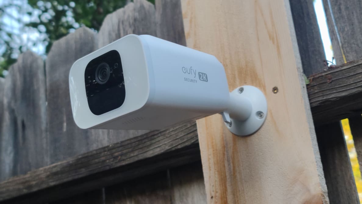Close up of an outdoor security camera posted to a fence.