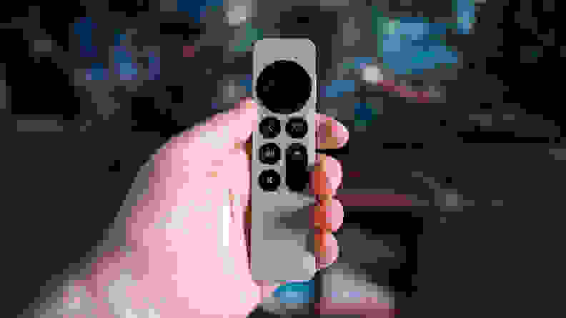 The Apple TV 4K remote held in hand
