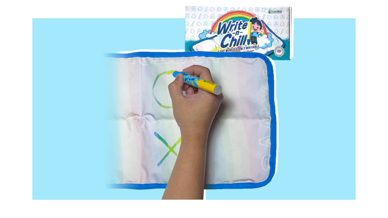 Child using the Writable Weighted Lap Pad to write colorful letters on cloth material.