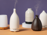 Five oil diffusers sitting on a table.