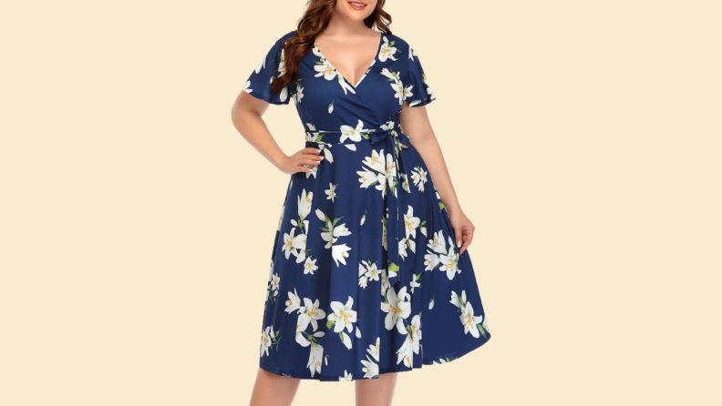 A woman wears a floral printed blue knee-length dress.