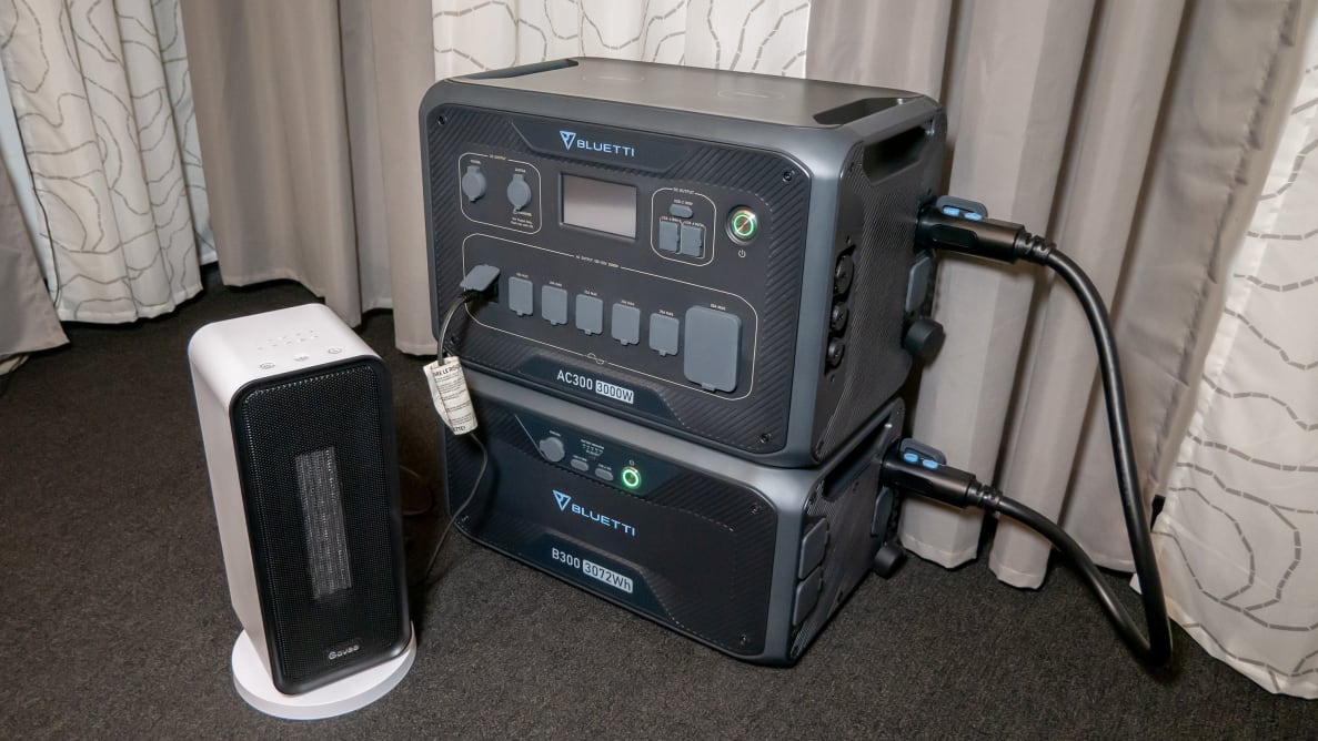 A Bluetti AC300+B300 Home Battery Backup appears in a carpeted room with a Govee electric space heater for testing.