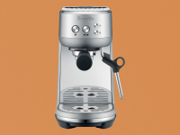 Breville Bambino espresso maker on brown paper-like background