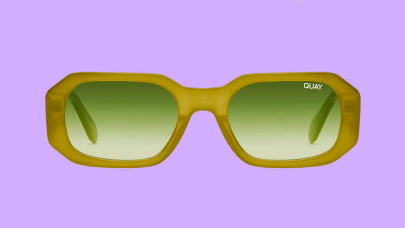An image of a pair of lime green, narrow sunglasses with bright green lenses.
