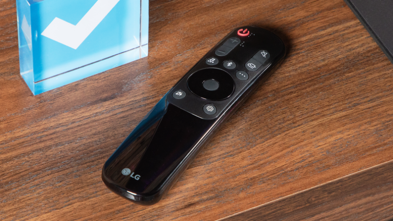 Close-up of a remote next to the Reviewed checkmark.