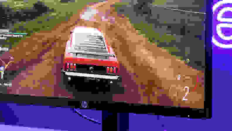 The monitor displaying a racing video game.