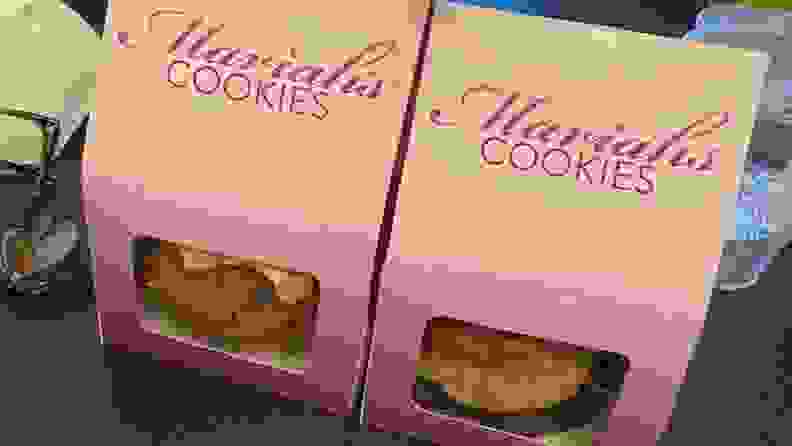 Two white and purple boxes of Mariah Carey's cookies sit on a kitchen counter.