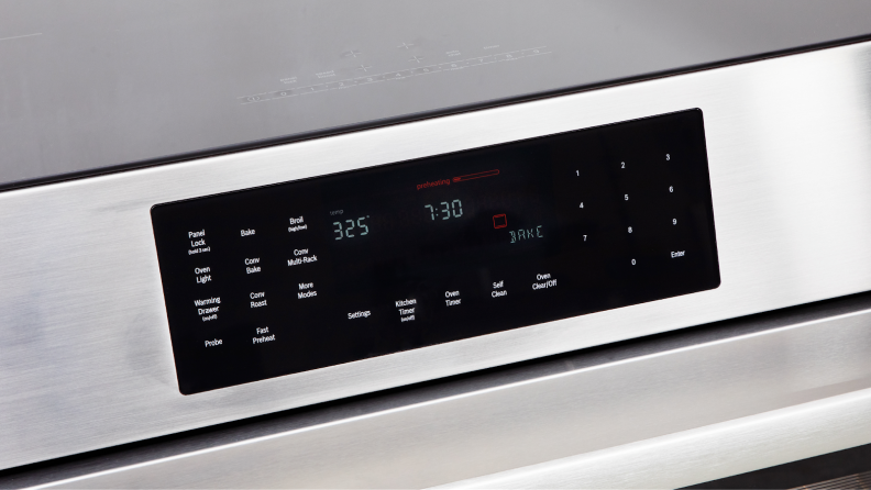 Close up view of the control panel with clock on the Bosch HII8057U 800 Series Induction Slide-in Range.