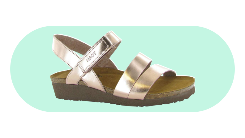 Naot Kayla sandal on a green background.