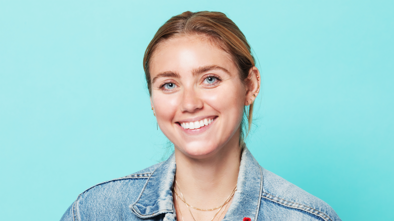 A woman smiling in makeup.