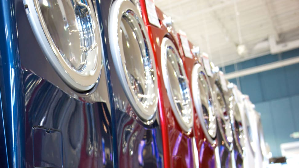 A line-up of shiny new washing machines.
