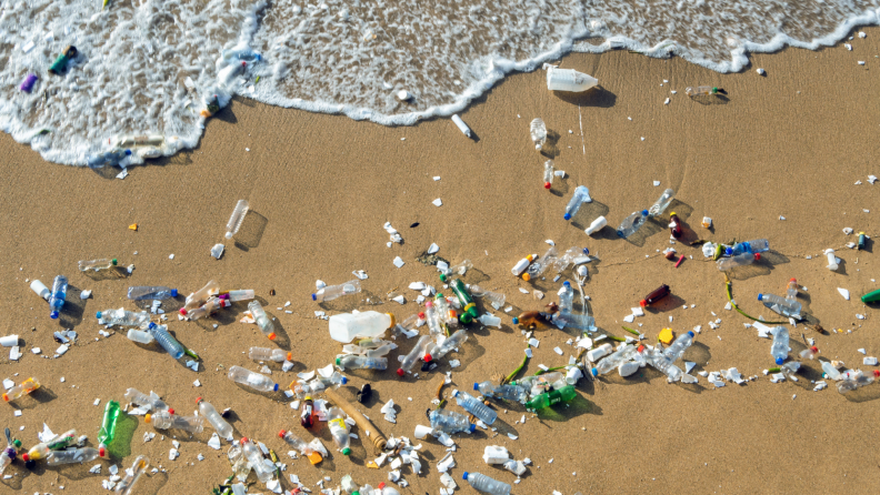 Plastic product littered all across the sand on the beach.