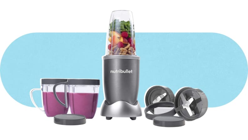 A filled NutriBullet NBR-1201 Blender next to two cups, with blended smoothies inside, and two blade attachments.
