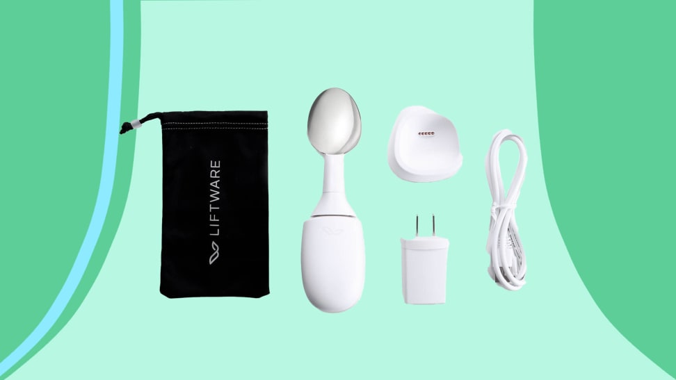 Liftware starter kit that includes level spoon, charging wall plug, cord and charging base, and storage bag.