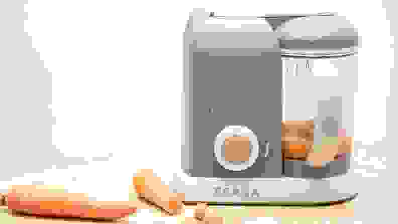 Carrots are blended into baby food with the use of a tabletop machine.