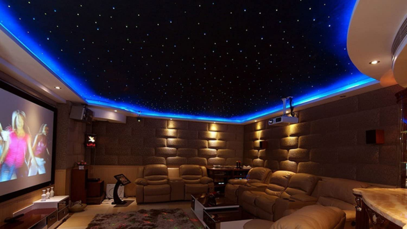 Theater-style living room with a sky-like ceiling with blue LED strips around the trim of the ceiling
