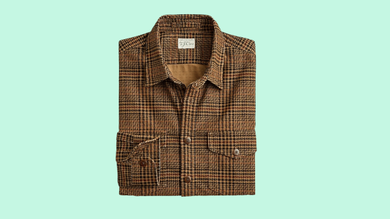 A plaid wool shirt with houndstooth print against a green background.