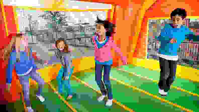 Kids jump in a bounce house at a birthday party.