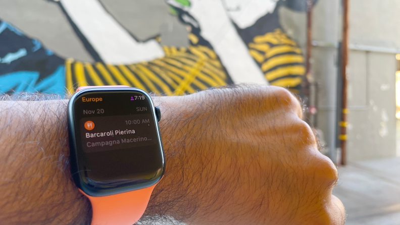 A person checks an Apple Watch fastened to their wrist featuring the Tripsy app.