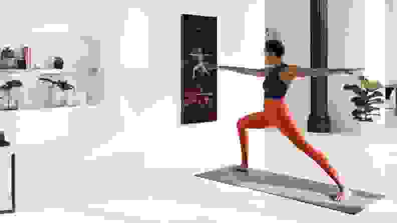 woman working out in front of digital mirror