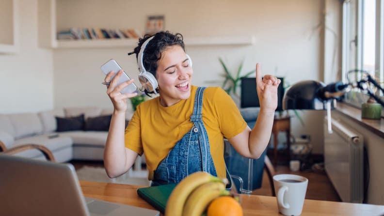 Image of woman dancing while listening to music in headphones