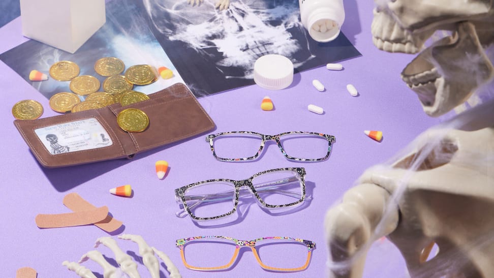 Halloween-themed eyewear on purple background with skeleton