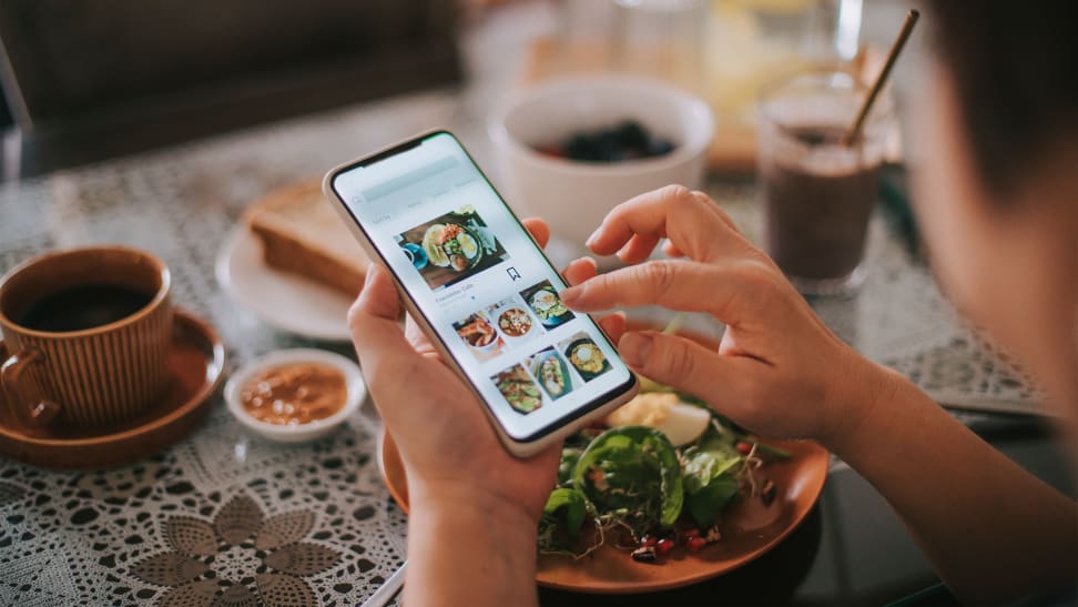A person using a food app while eating.