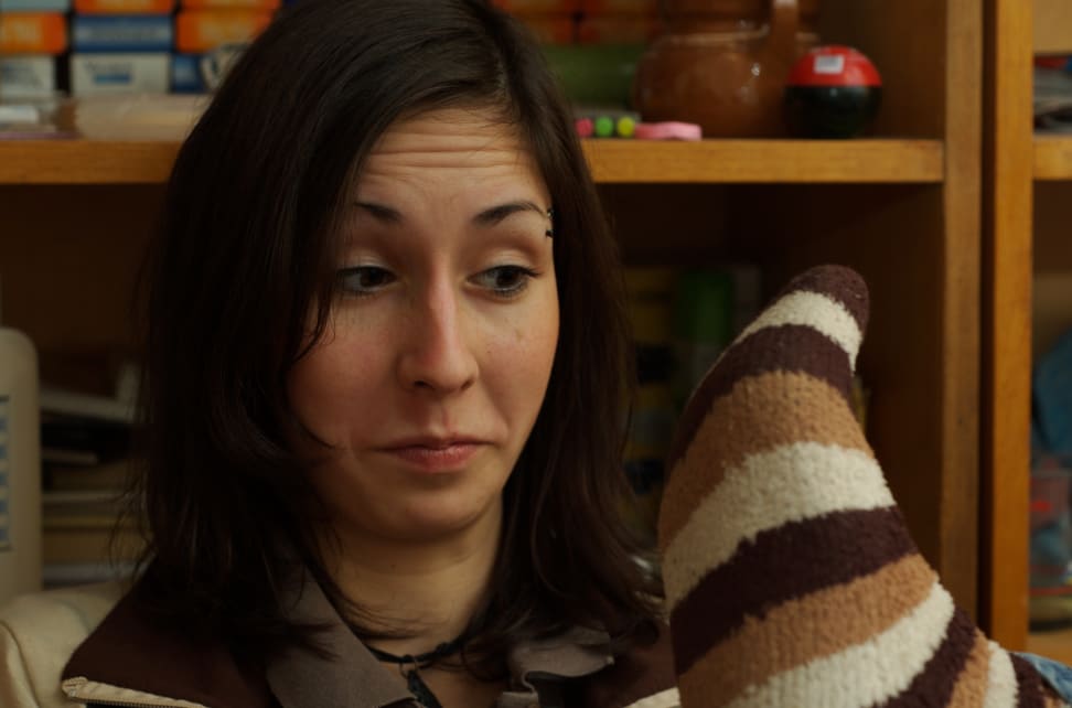 A stinky sock in a woman's face