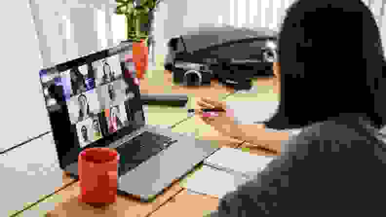 a woman sits with coffee during video chat