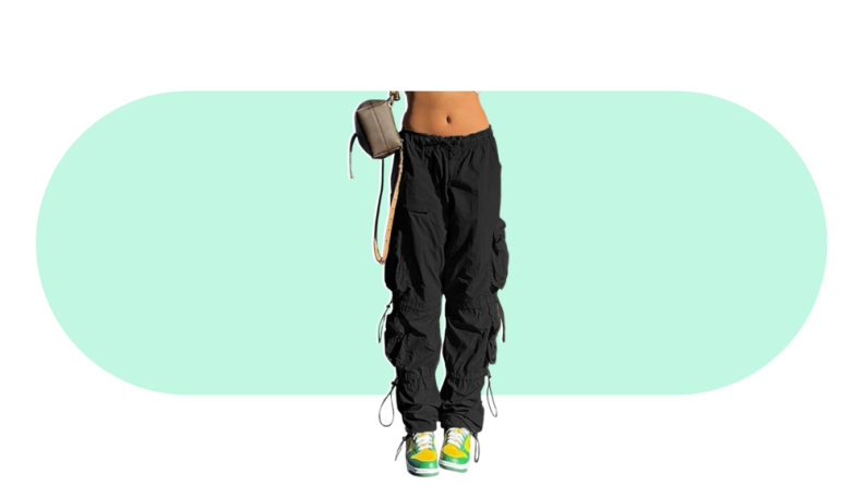 A model seen from the waist down, wearing black cargo pants with laces hanging at the sides.