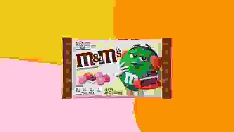 Black Forest M&M packaging on an orange, yellow, and pink background