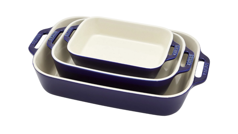 An image of three blue and white Staub baking dishes stacked together.