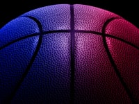 An image a red, pink, purple, and blue basketball seen up close.