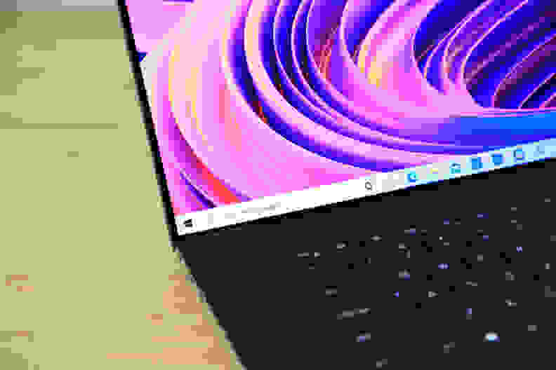 A close up of a laptop display showing off colorful wallpaper.