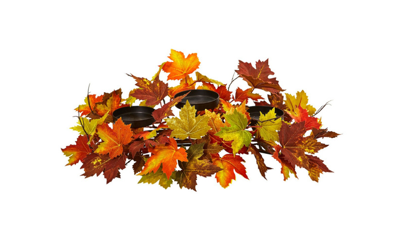 An image of a black three-candle candelabrum wrapped in autumn leaves.