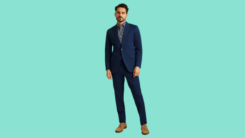 A model wears a navy suit with a floral shirt.