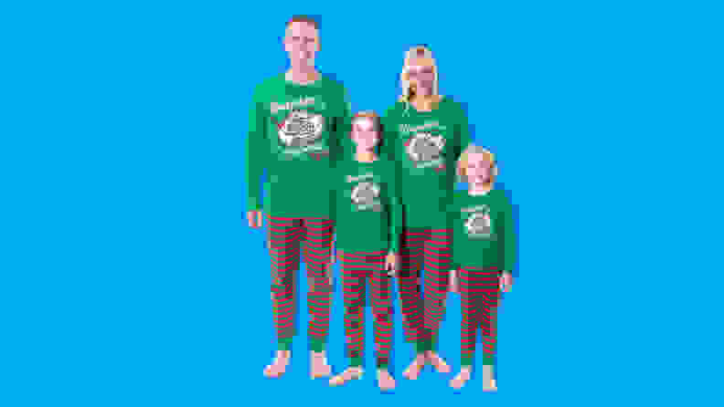 A family wearing the INTIMO A Christmas Story Ralphie the Kid family pajama set on a blue background.