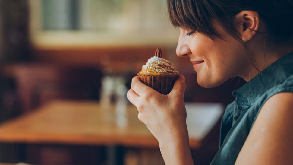 Person sniffing cupcake.