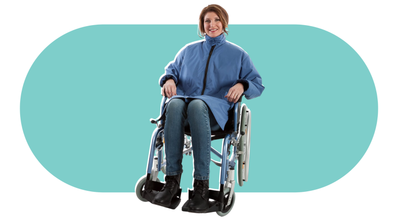 A woman in a wheelchair wearing a blue adaptive coat that covers her torso and neck