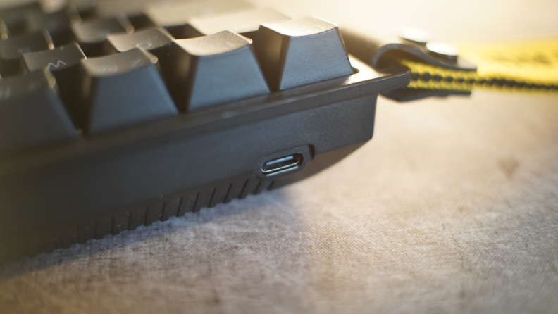 Close up angled view of side of the Wooting 60he keyboard with a usb type c port near bottom.